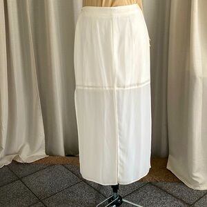 Long skirt with miniskirt lining, four slits cream color.
